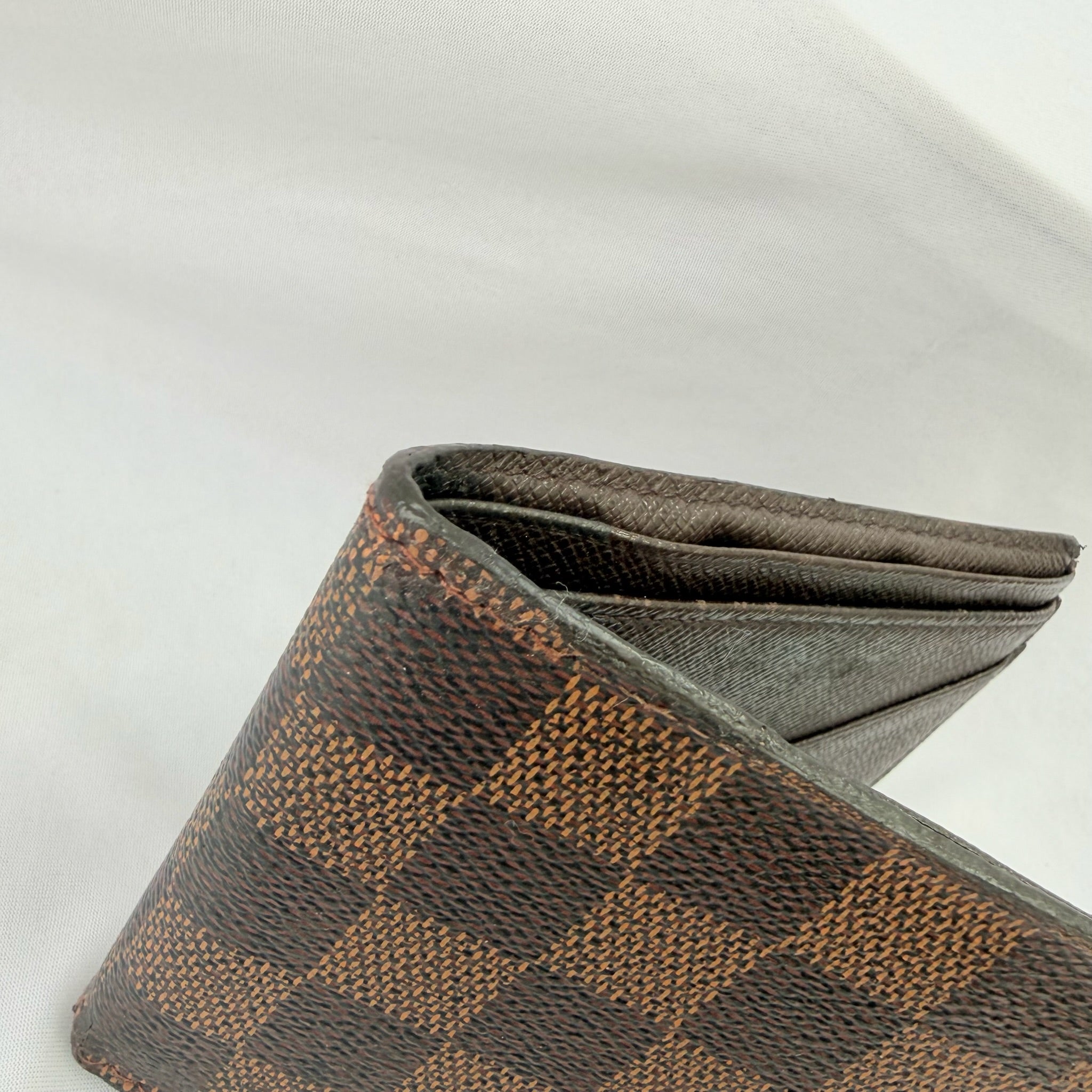 Louis Vuitton Bifold wallet Damier Ebène Coated Canvas Brown Repaired